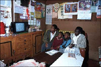 Eric Mucharia and family at home watching TV